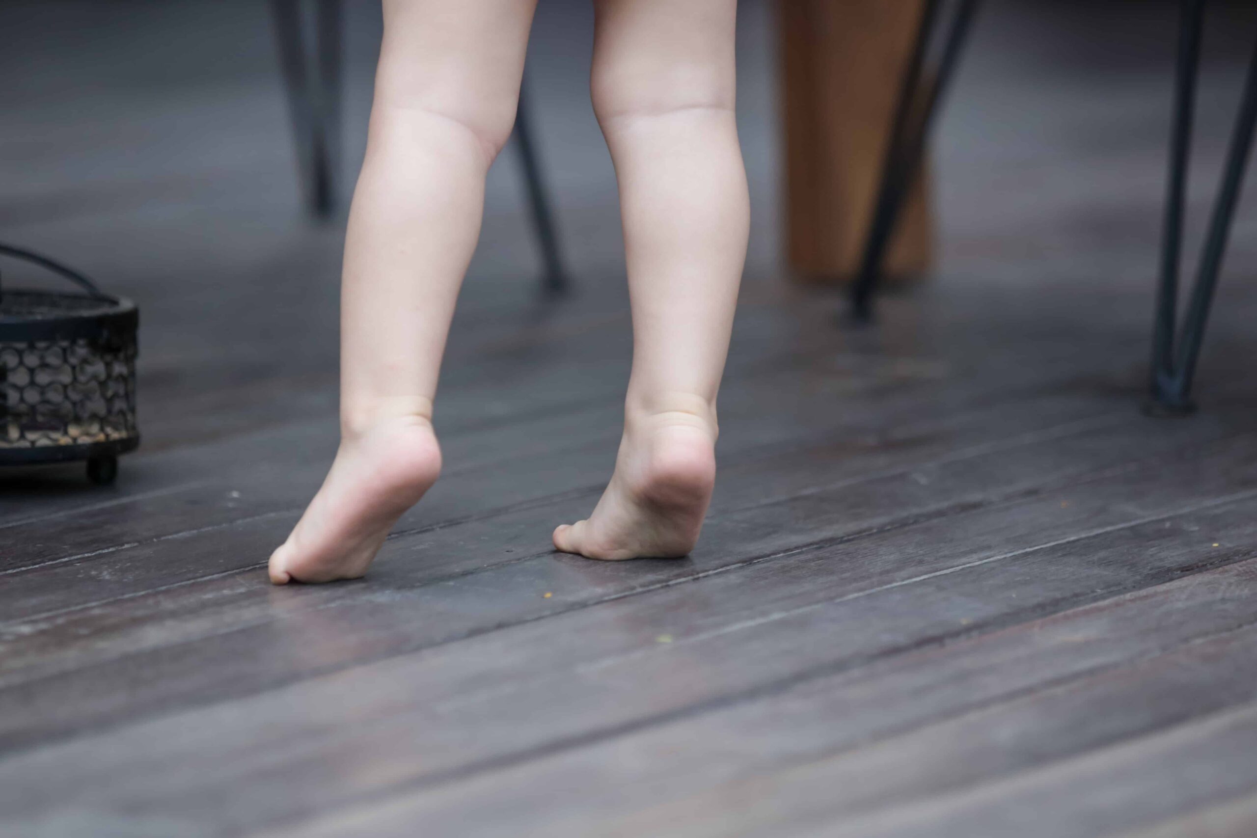 A child walking on tiptoes, toe walking close up